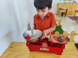 Boy Play with weighing scale at Sneha's Imagination Station