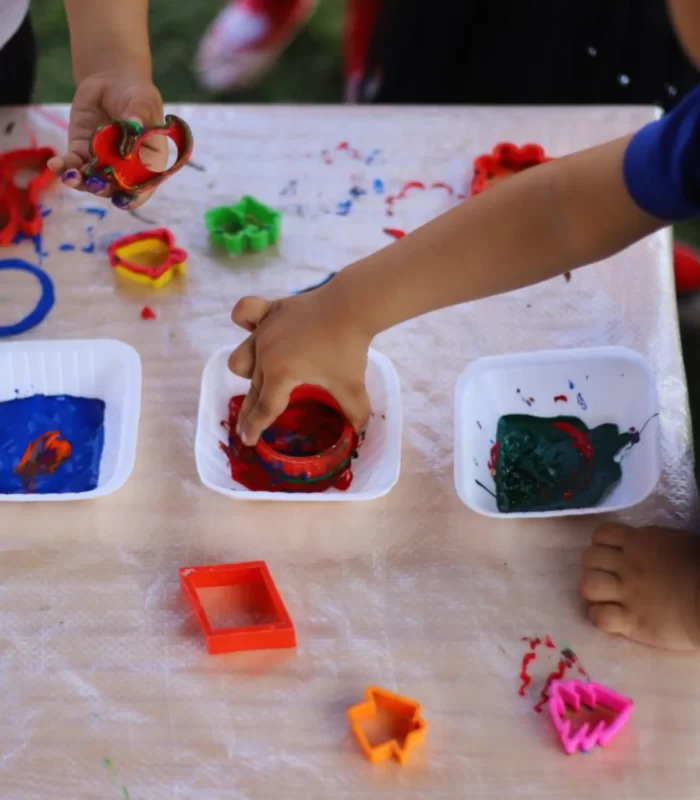 Children play with color blocks on table at Sneha's Imagination Station